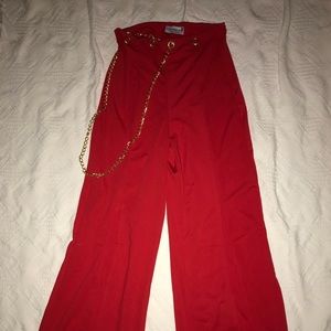 Fashionable red pants with gold chain.